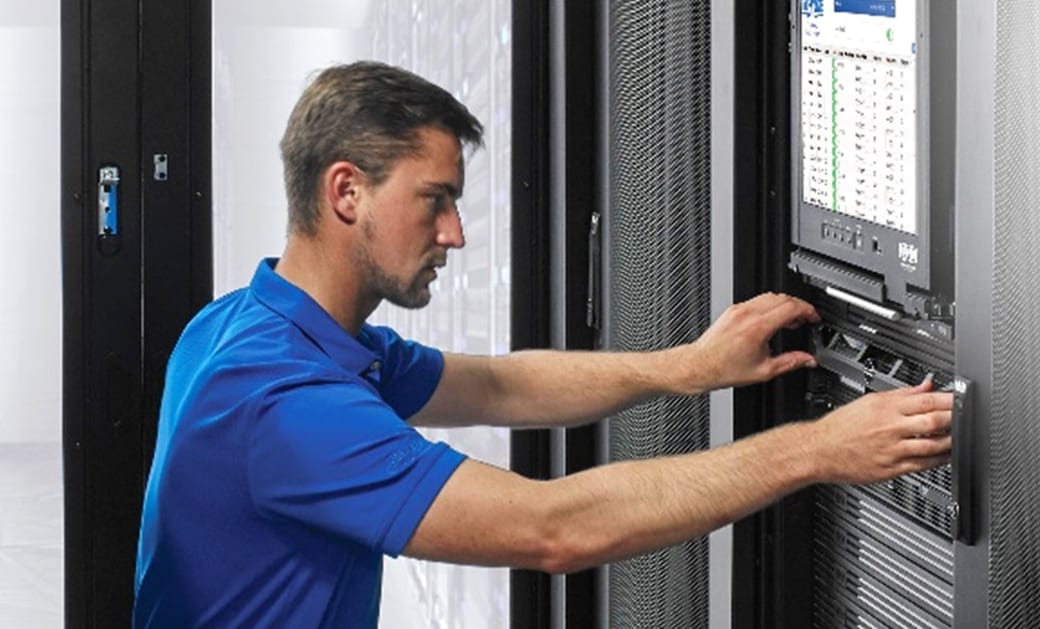 A technician cabling a rack of our equipment